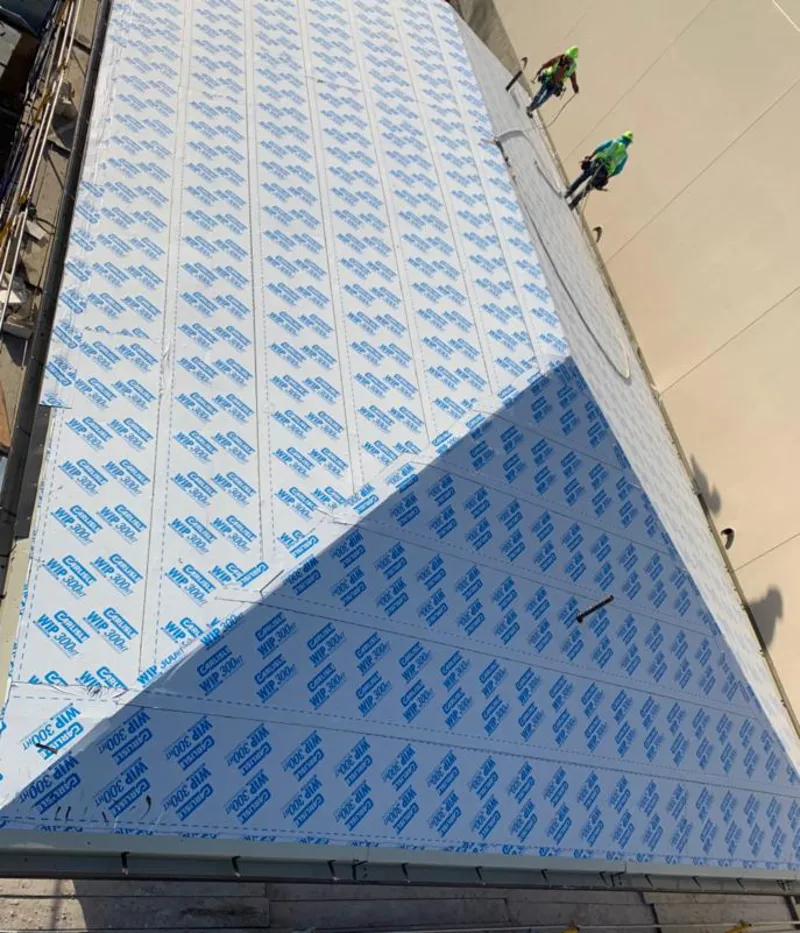 Professional roofers installing underlayment on a metal roof in Castle Shannon